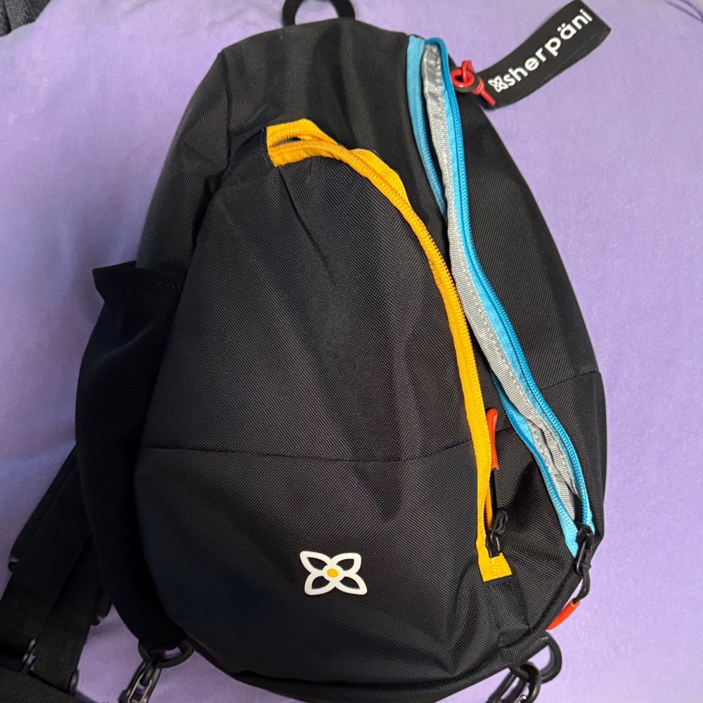 Sherpani Black Backpack with Orange and Blue Highlights